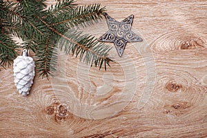 Christmas ornaments and fir tree branch on a rustic wooden background. Xmas card. Happy New Year. Top view