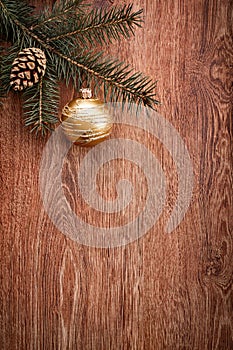 Christmas ornaments and fir tree branch on a rustic wooden background. Xmas card. Happy New Year. Top view