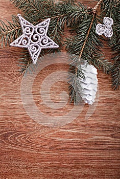 Christmas ornaments and fir tree branch on a rustic wooden background. Xmas card. Happy New Year. Top view