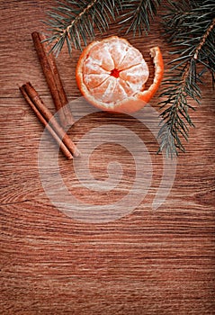 Christmas ornaments, food decor and fir tree branch on a rustic wooden background. Xmas card. Happy New Year. Top view