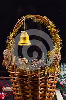 Christmas ornaments with garland of beads, pine cones and acorns laying in a basket