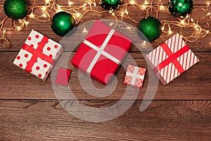 Christmas ornaments and gifts on a wooden table. Holidays christmas background. Copy space for text or design. View from above