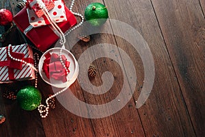 Christmas ornaments and gifts on a wooden table. Holidays christmas background. Copy space for text or design. View from above