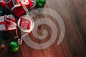 Christmas ornaments and gifts on a wooden table. Holidays christmas background. Copy space for text or design. View from above