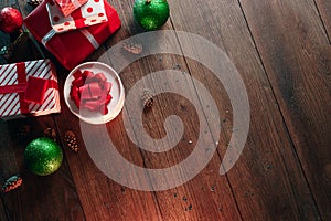 Christmas ornaments and gifts on a wooden table. Holidays christmas background. Copy space for text or design. View from above