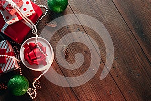 Christmas ornaments and gifts on a wooden table. Holidays christmas background. Copy space for text or design. View from above