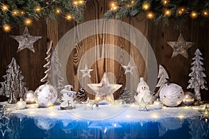 Christmas ornaments, lights and wooden background