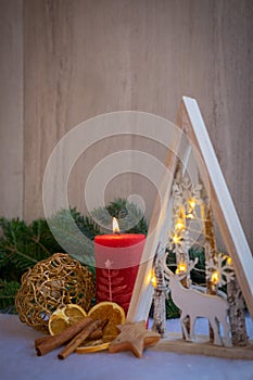 Christmas ornaments with snow, pine tree, red candle and xmas lights