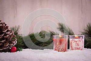 Christmas ornaments with snow, pine tree, red candle and xmas lights