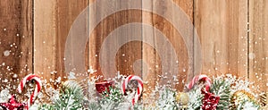 Christmas ornaments with snow on wood background