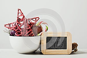 Christmas ornaments and text happy holidays