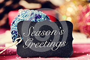 Christmas ornaments and text seasons greetings