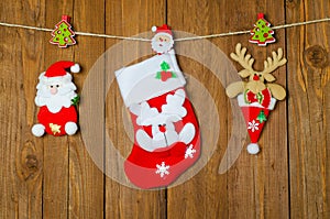 Christmas ornaments on the wooden background hanging on a rope.