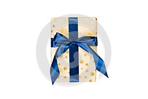 Christmas or other holiday handmade present in gold paper with blue ribbon. Isolated on white background, top view. thanksgiving