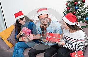 Christmas party with friends, asia people exchange gift and giving present with smiling face,Holiday xmas celebration concept