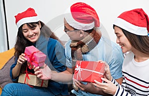 Christmas party with friends, asia people exchange gift and giving present with smiling face,Holiday xmas celebration concept