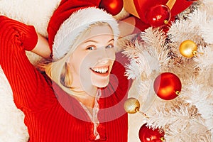 Christmas party. Santa fun. New year woman. Fashion portrait of girl indoors with Christmas tree. Funny girl in santa