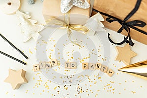 Christmas party time confetti, gifts, tree, stars, glitter, ribbon. Party time lettering. New year 2022. Top view, banner
