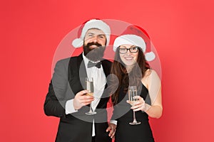 Christmas party time. formal couple in love celebrate new year. tuxedo man with woman in santa hat. merry christmas and