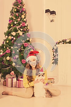 Christmas party, winter holidays woman with cat. New year girl. christmas tree in interior