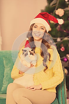 Christmas party, winter holidays woman with cat. New year girl. christmas tree in interior