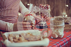 Christmas pastry shop. Woman seller, waitress ringing bell to warn that home made gingerbread cookies is ready. Selling