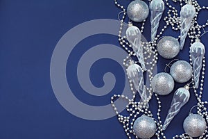 Christmas pattern with beautiful toys. New year decorations on a dark blue background. Top view, flat lay