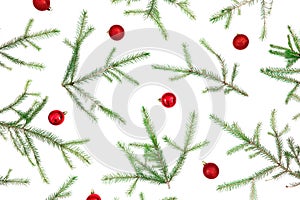 Christmas pattern of fir branches and red decoration on white background. Flat lay