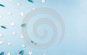 Christmas pattern made of snowflake, stars and christmas tree on pastel blue background. Winter concept, top view with copy space