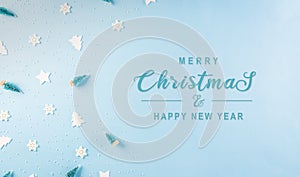 Christmas pattern made of snowflake, stars and christmas tree on pastel blue background. Winter concept, top view with copy space