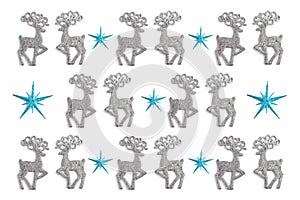 Christmas pattern made of stars and silver color toys deer on white background. winter concept, flat lay, top view