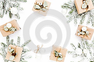 Christmas pattern, texture made in of craft boxes and green branches in the snow. Holiday and celebration concept. Top