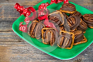 Christmas pecan nuts on melted chocolate and pretzel