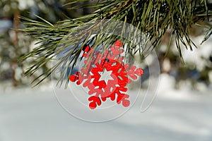 Christmas pendant toy red snowflake skates hanging on a Christmas tree branch