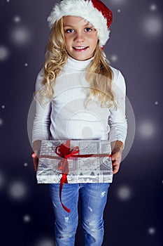 Christmas photo of cute little blond girl with presents