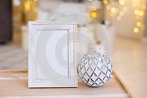 Christmas photo frame mock up template with decoration on wooden table.