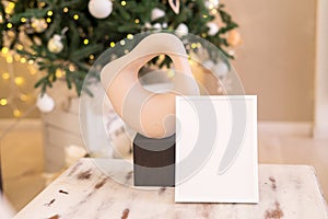 Christmas photo frame mock up template with decoration on wooden table.