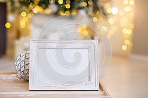 Christmas photo frame mock up template with decoration on wooden table.