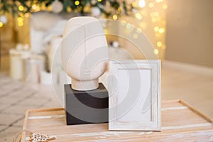 Christmas photo frame mock up template with decoration on wooden table.