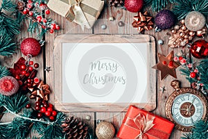 Christmas photo frame mock up template with decoration on wooden table.