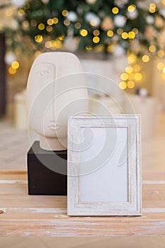 Christmas photo frame mock up template with decoration on wooden table.