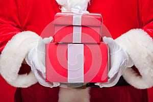 Christmas Photo of Santa Claus gloved hand with red giftbox