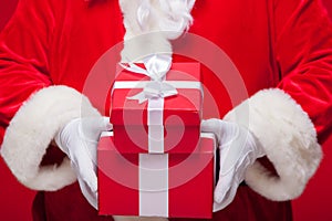 Christmas Photo of Santa Claus gloved hand with red giftbox