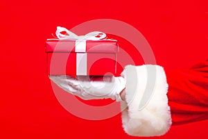 Christmas Photo of Santa Claus gloved hand with red giftbox