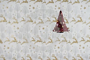 Christmas photography image christmas decoration hanging up of soft red sequin xmas tree with reindeer wrapping paper background