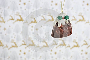 Christmas photography image christmas decoration hanging up of xmas pudding cream holly with reindeer wrapping paper background
