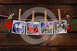 Christmas photos hanging on rope against wooden background