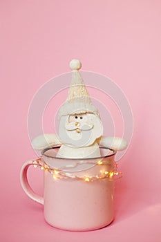 Christmas picture of cup with Santa toy and lights