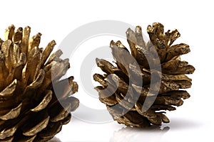 Christmas pine cones resting on a white table