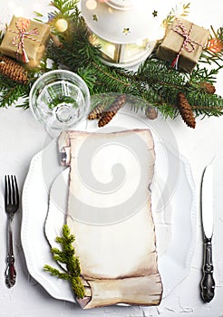 Christmas place setting with blank paper for writing the Christmas menu